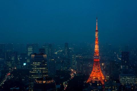 Neon-lit Tokyo skyline at night with crowded streets and glowing signs