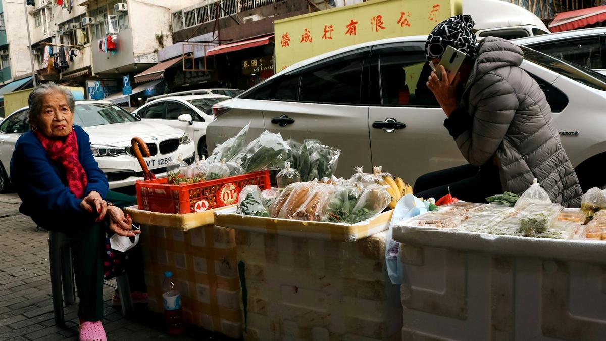 A local vendor at a small market stall in an underrated city