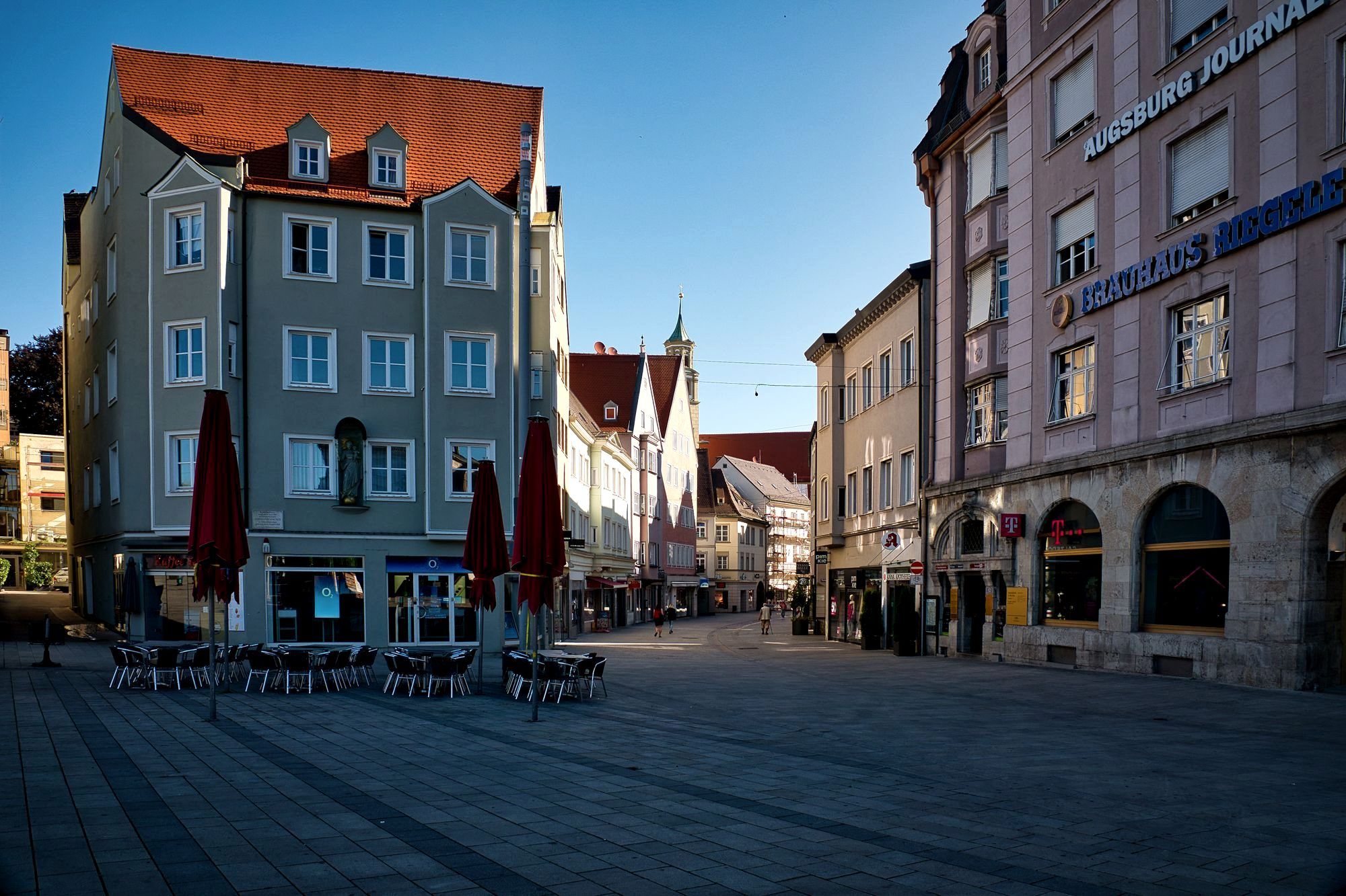 A calm cobblestone square in an underrated European old town at morning