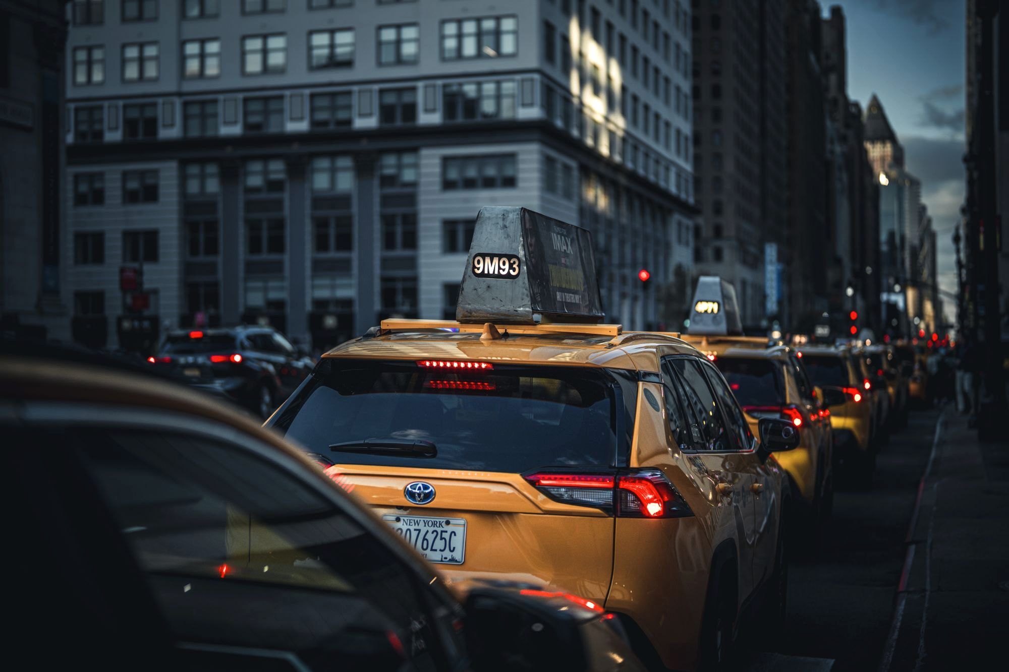 Yellow taxis lined up outside JFK airport arrivals in New York City