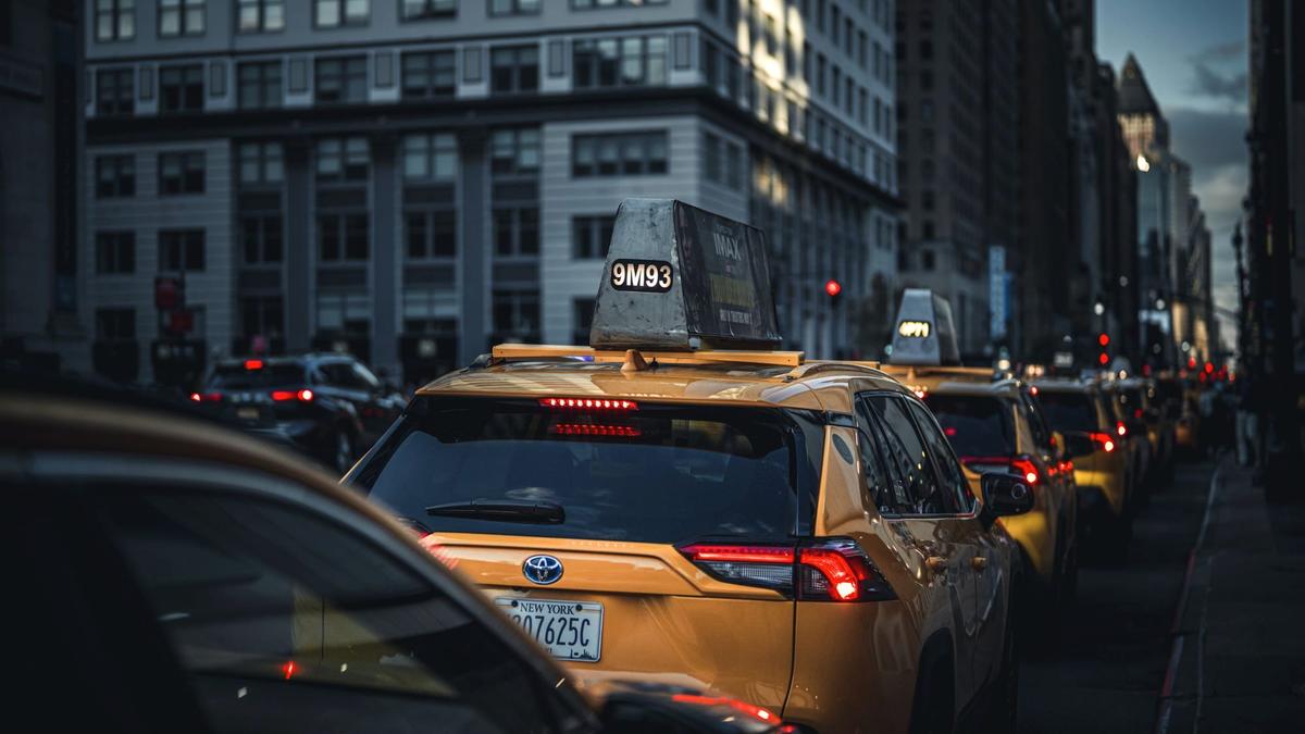 Yellow taxis lined up outside JFK airport arrivals in New York City