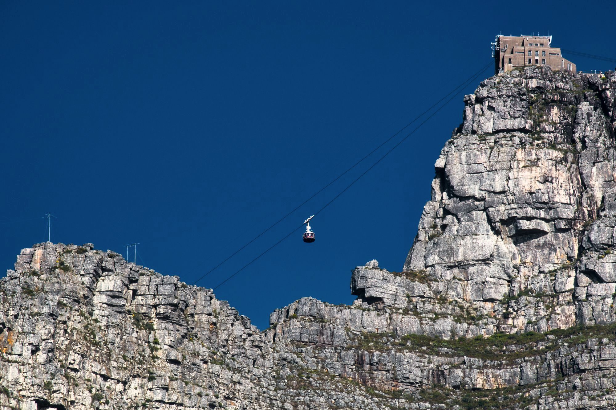 The rotating cable car climbing the cliffs of Table Mountain above Cape Town