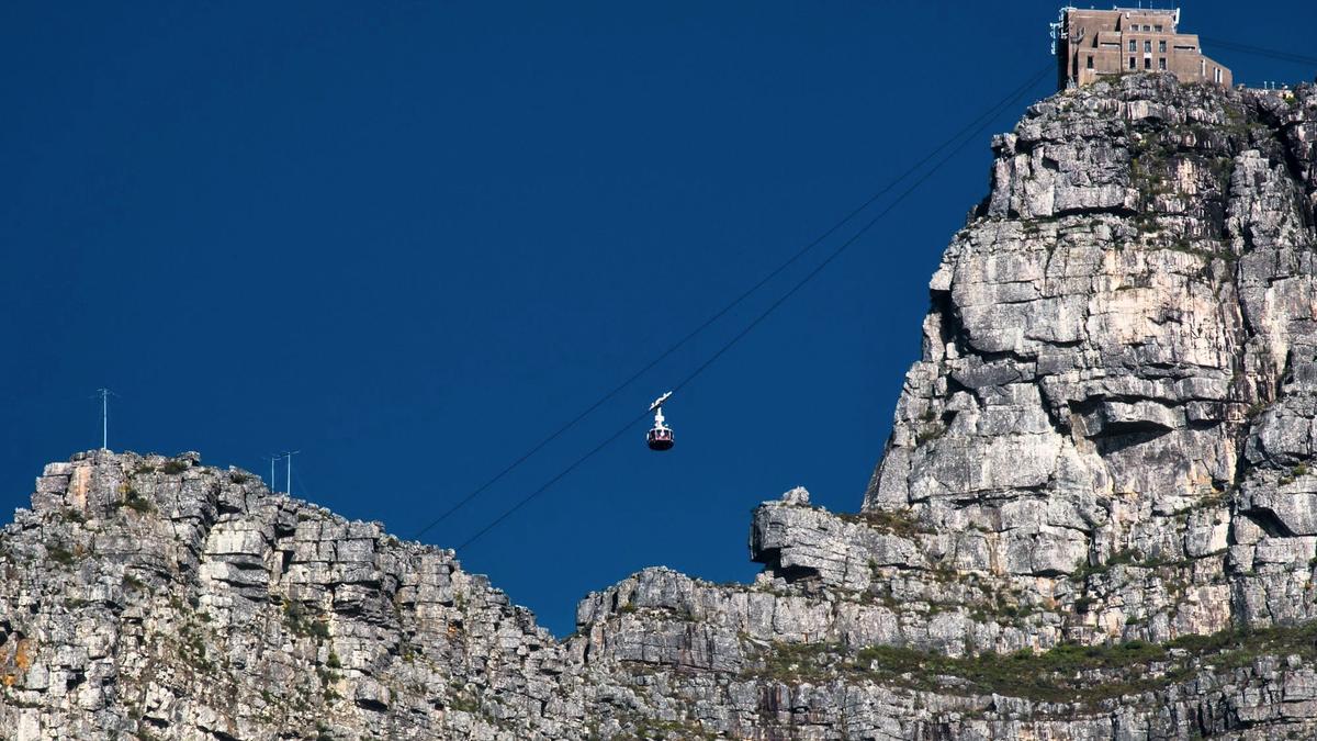 The rotating cable car climbing the cliffs of Table Mountain above Cape Town