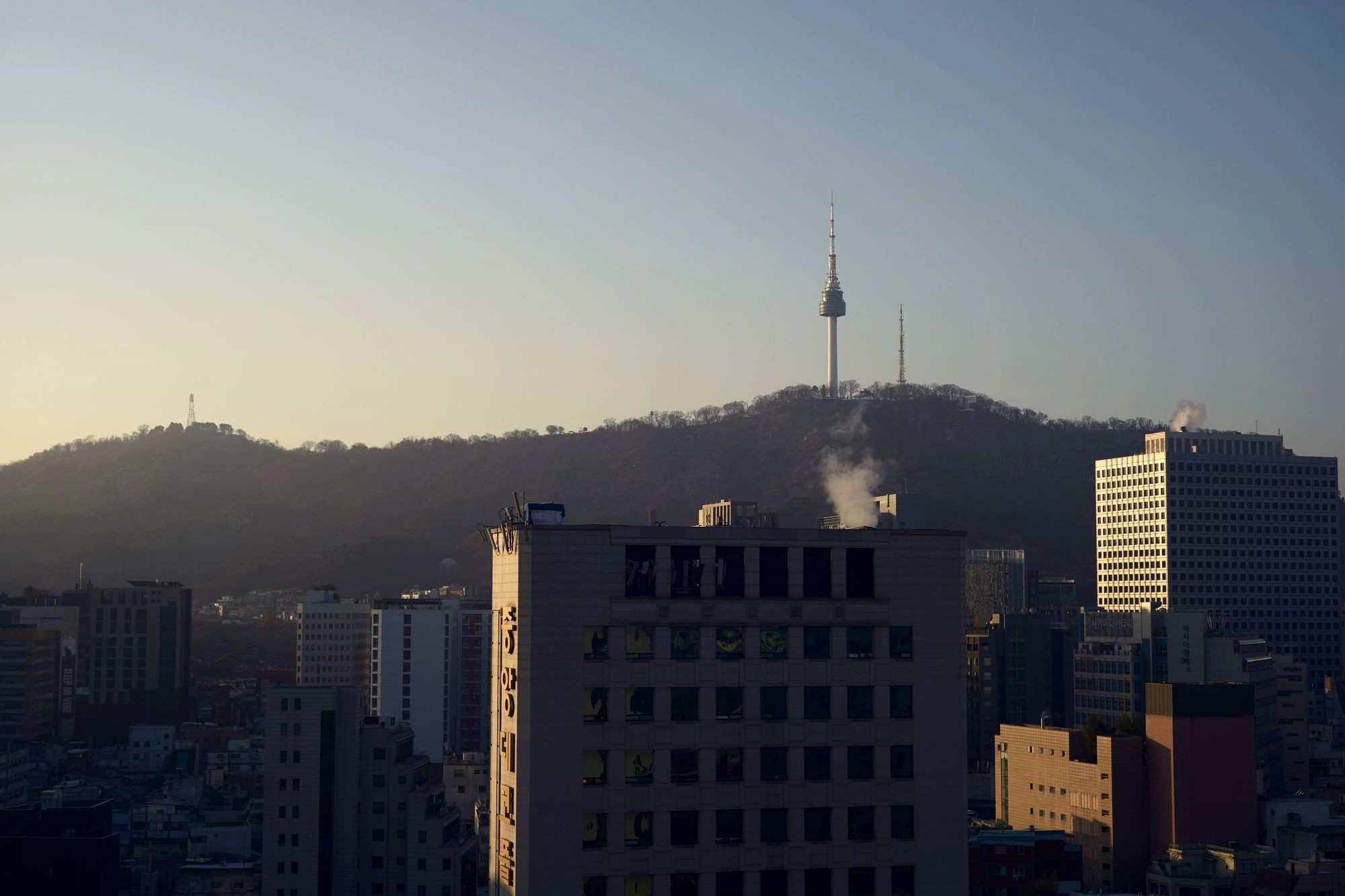 The N Seoul Tower lit up on Namsan hill above the city skyline at dusk