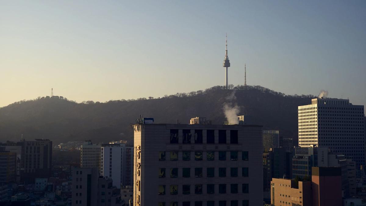 The N Seoul Tower lit up on Namsan hill above the city skyline at dusk