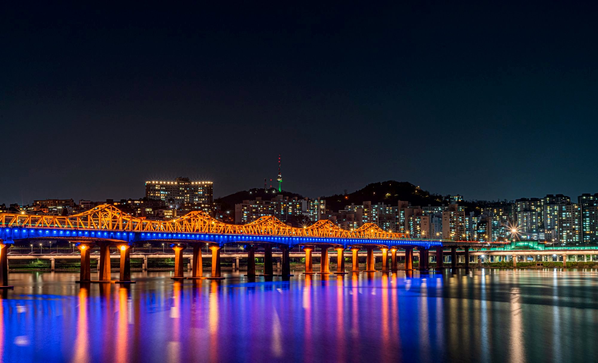 Seoul city skyline at night with N Seoul Tower lit on the hill