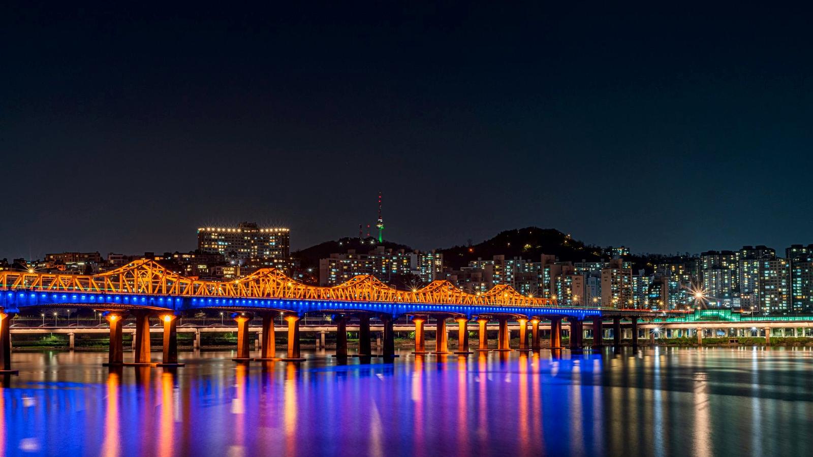Seoul city skyline at night with N Seoul Tower lit on the hill