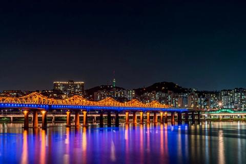 Seoul city skyline at night with N Seoul Tower lit on the hill