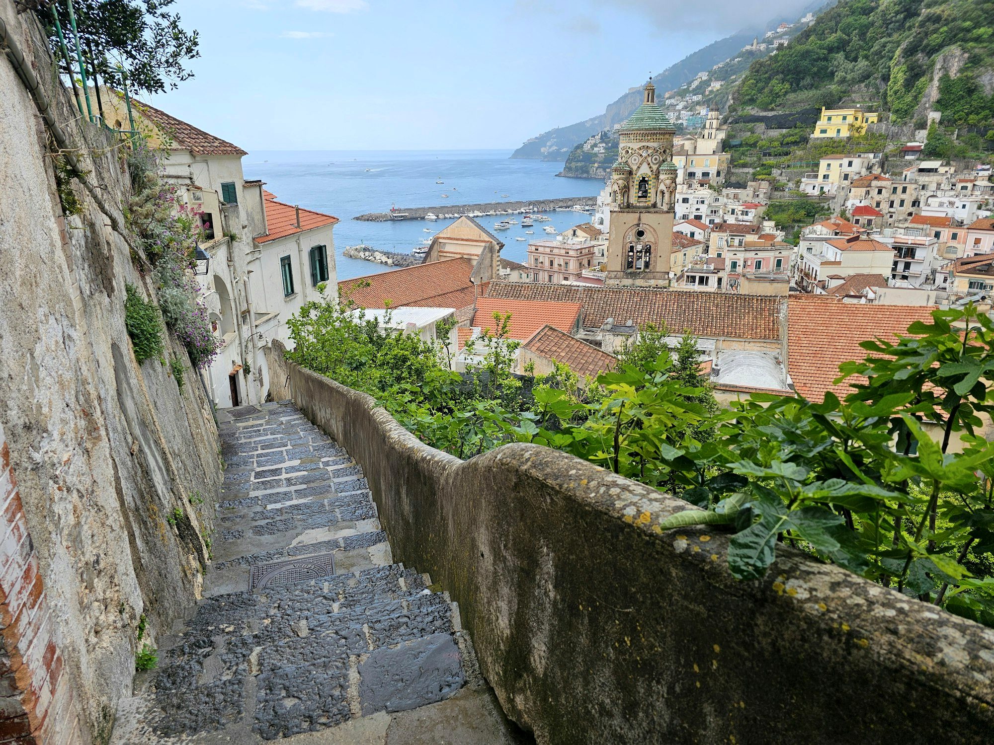 The striped facade and steep steps of the Duomo di Amalfi in the town center