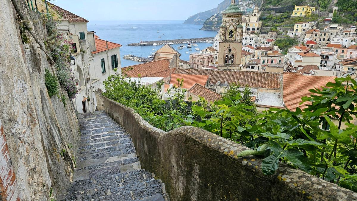 The striped facade and steep steps of the Duomo di Amalfi in the town center