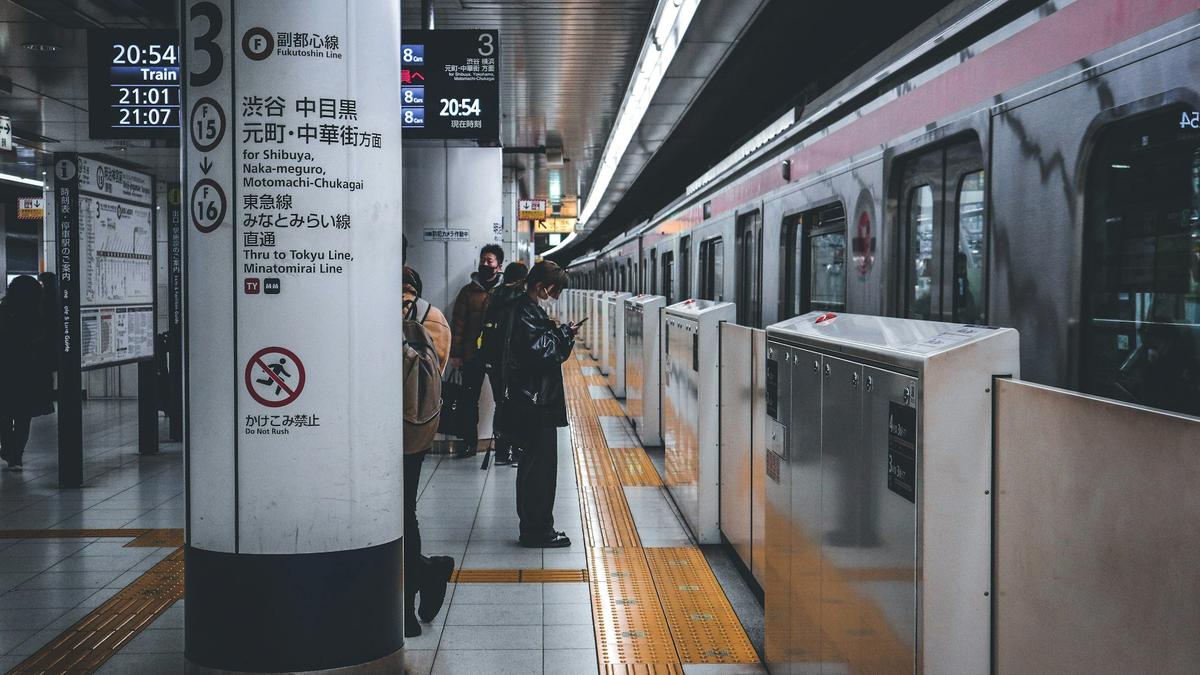 Commuters passing through a busy Tokyo subway station