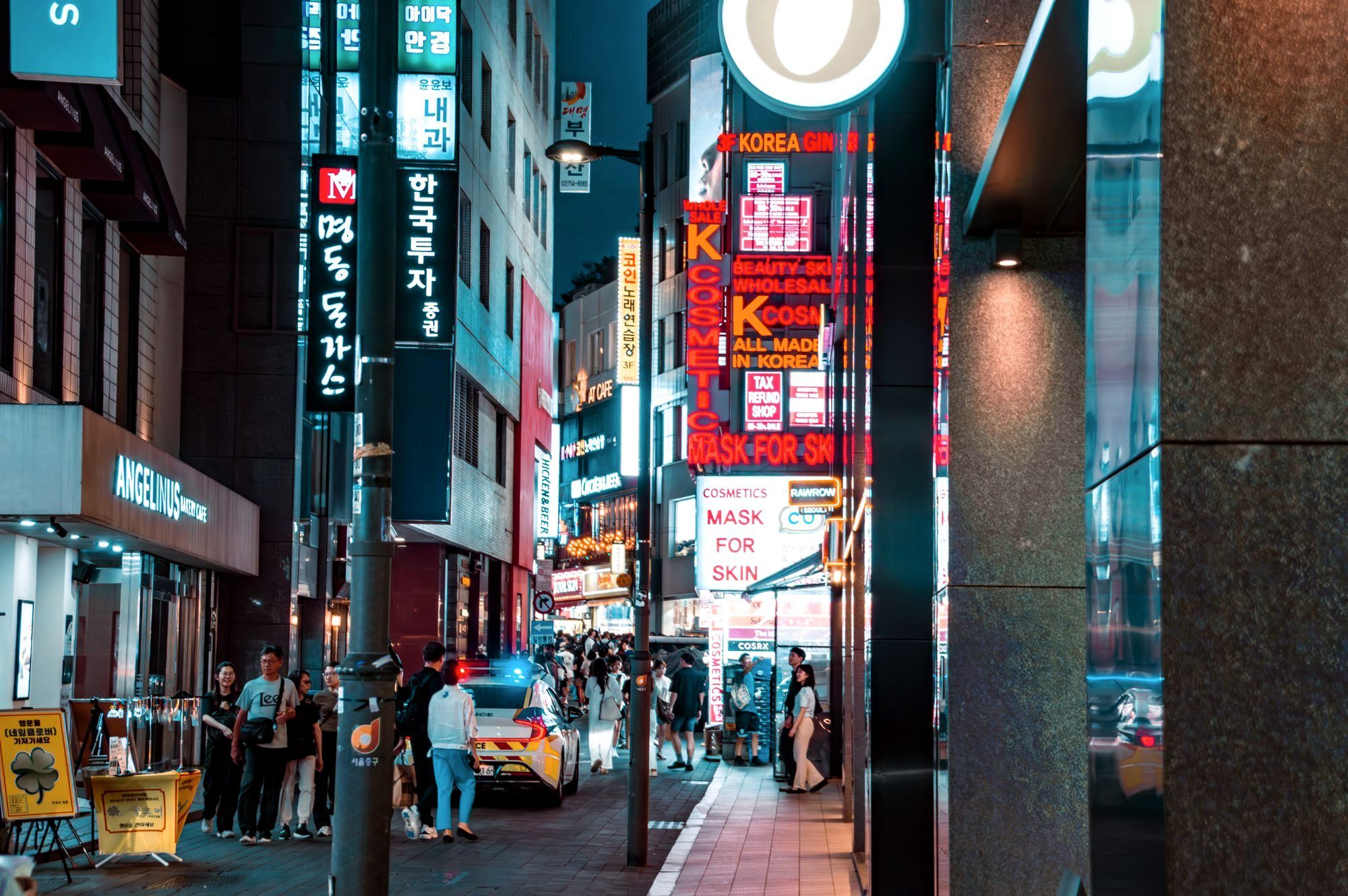 Crowded Myeongdong shopping street in Seoul lit up at night