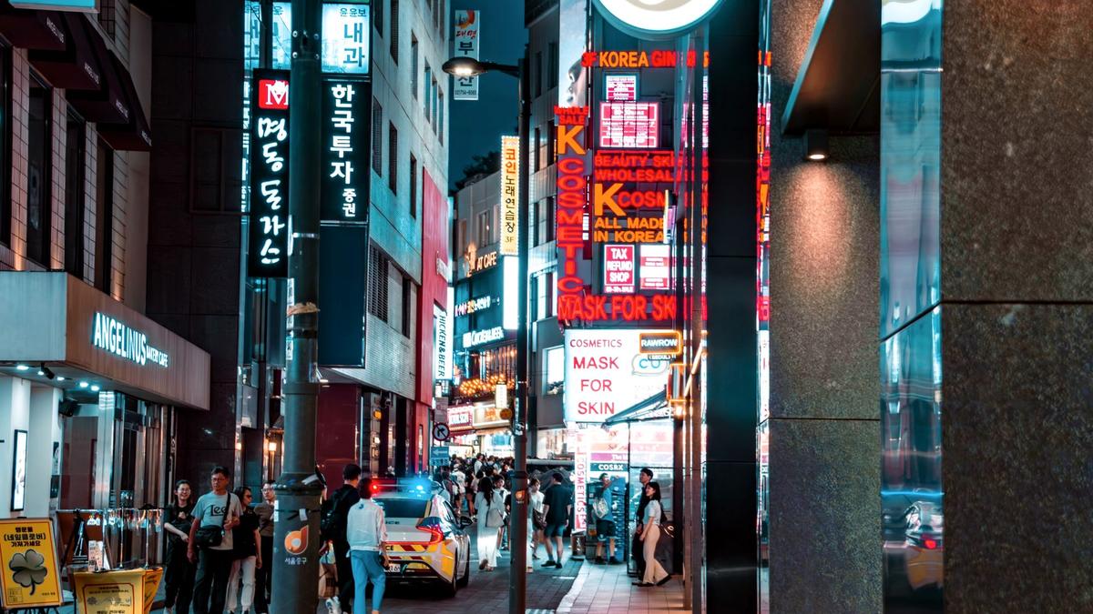 Crowded Myeongdong shopping street in Seoul lit up at night