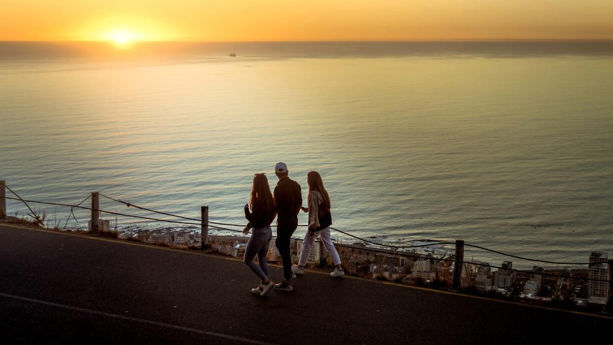 Sunset over the Atlantic and the city lights seen from Signal Hill in Cape Town