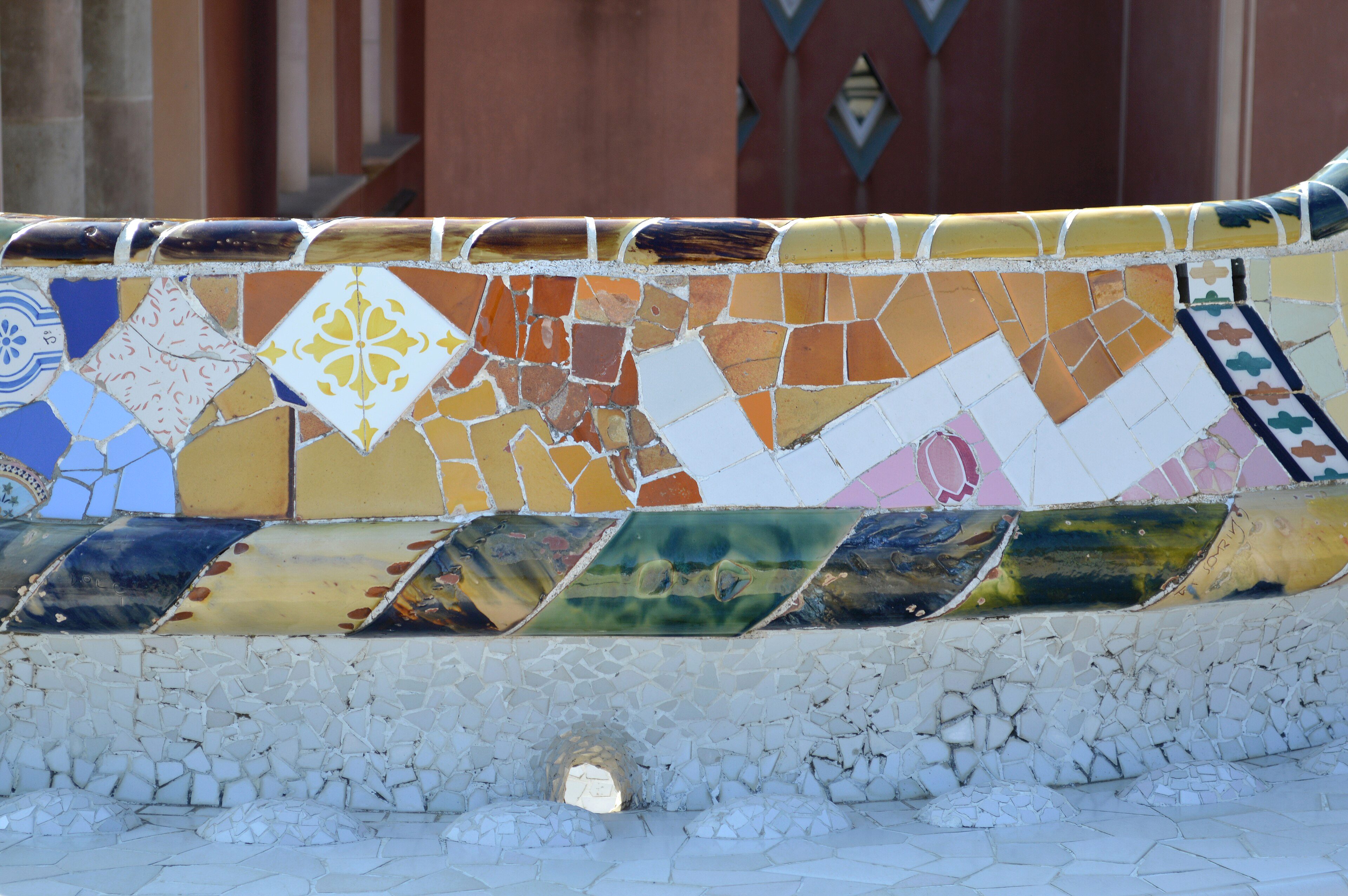 The colorful mosaic serpentine bench curving around the main terrace at Park Güell, Barcelona