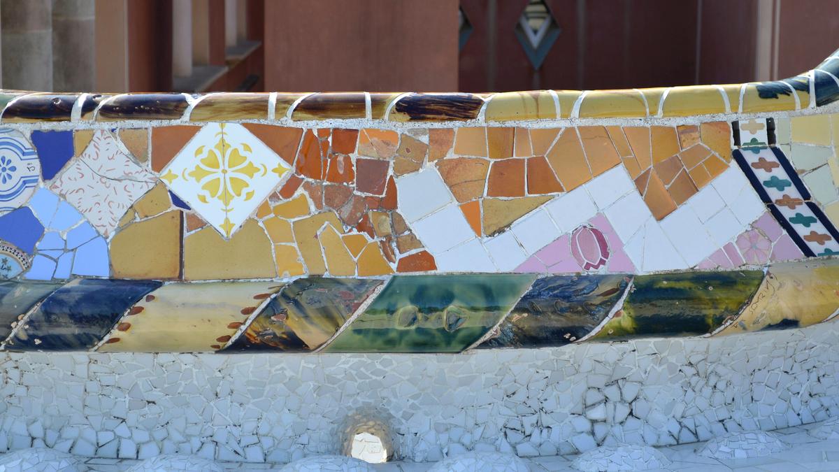 The colorful mosaic serpentine bench curving around the main terrace at Park Güell, Barcelona