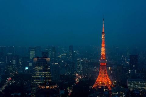 Neon-lit Tokyo skyline at night with crowded streets and glowing signs