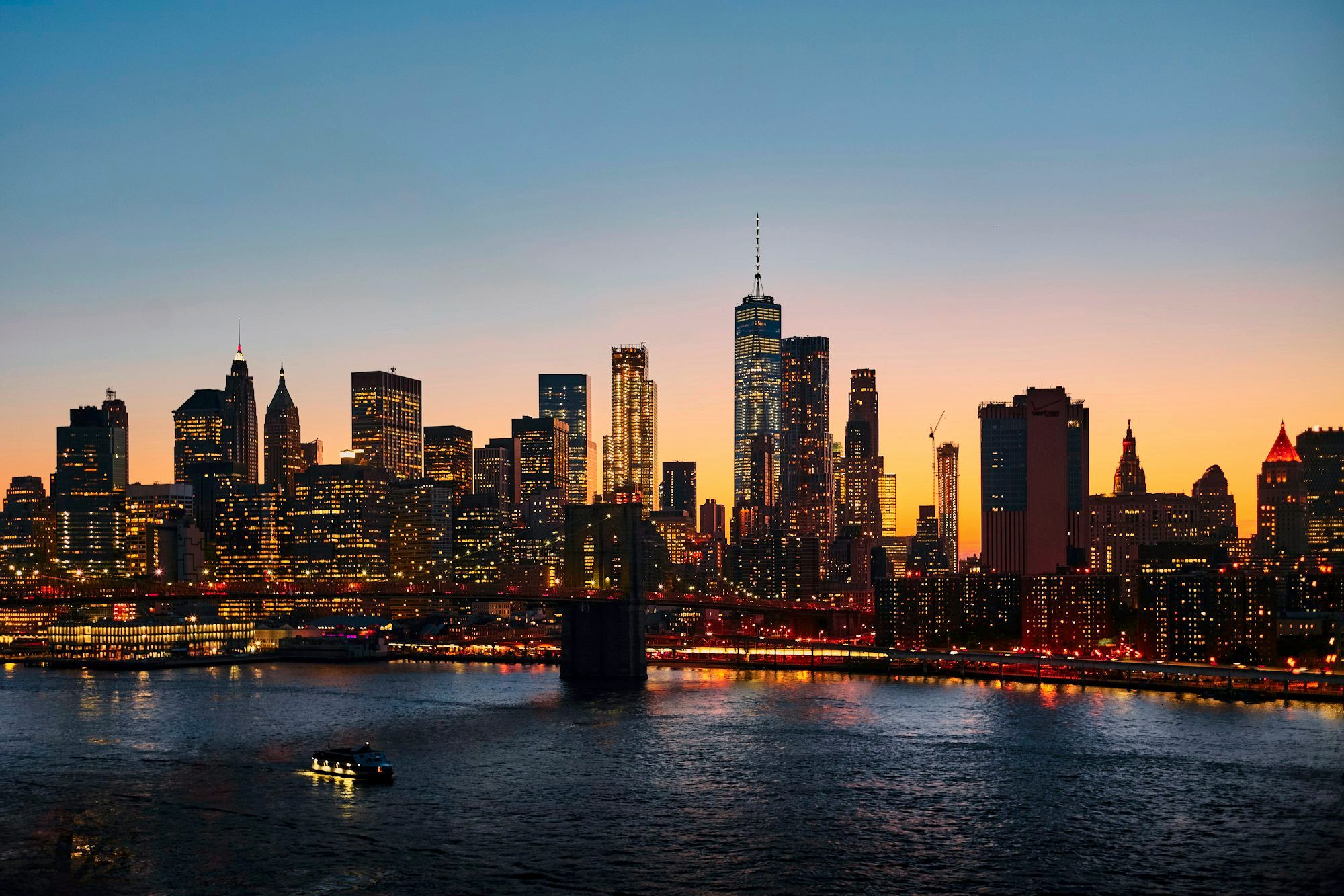 Yellow taxis on a Manhattan street below the New York City skyline