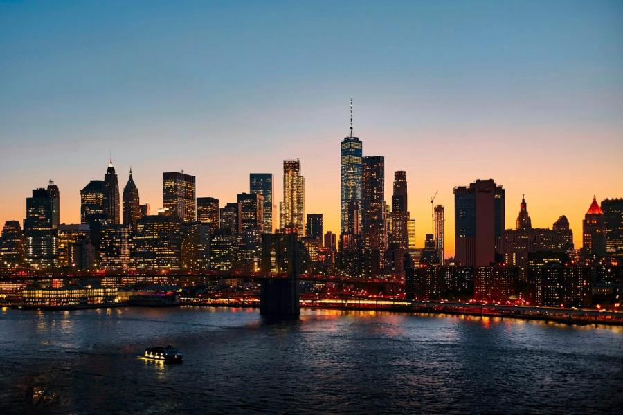 Yellow taxis on a Manhattan street below the New York City skyline