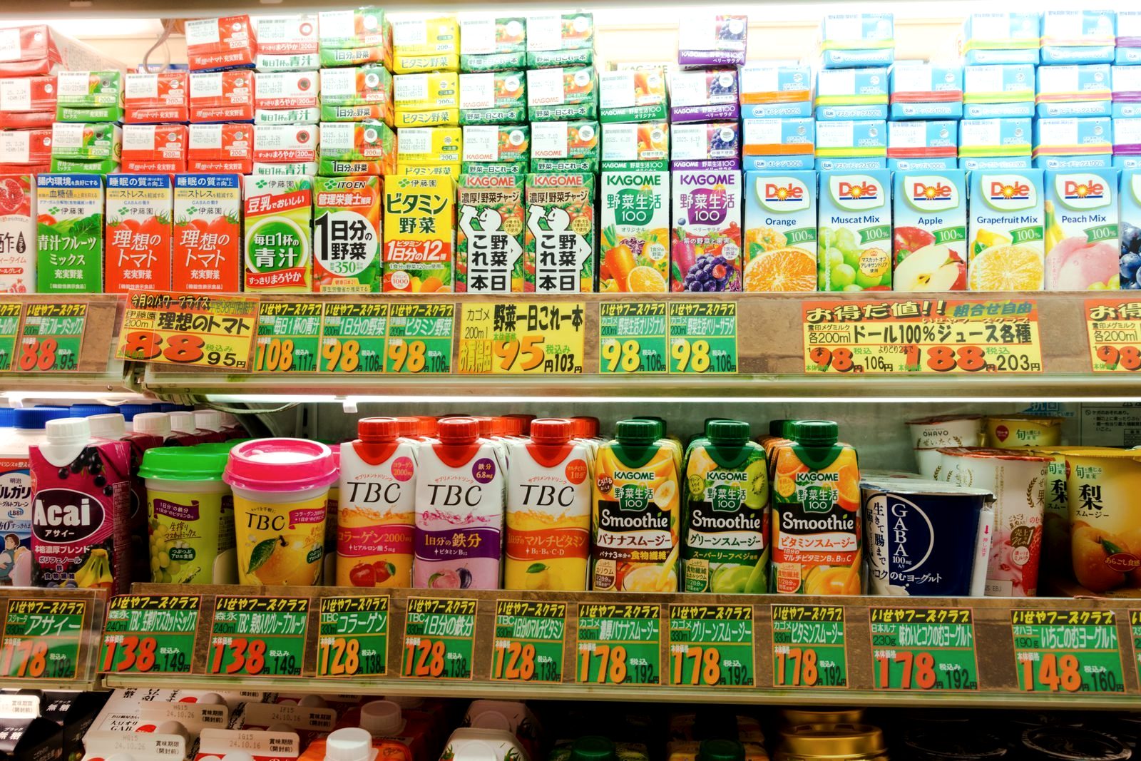 Shelves of cheap drinks and snacks with yen price tags in a Japanese convenience store