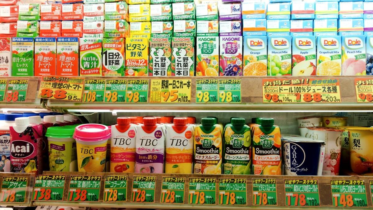 Shelves of cheap drinks and snacks with yen price tags in a Japanese convenience store