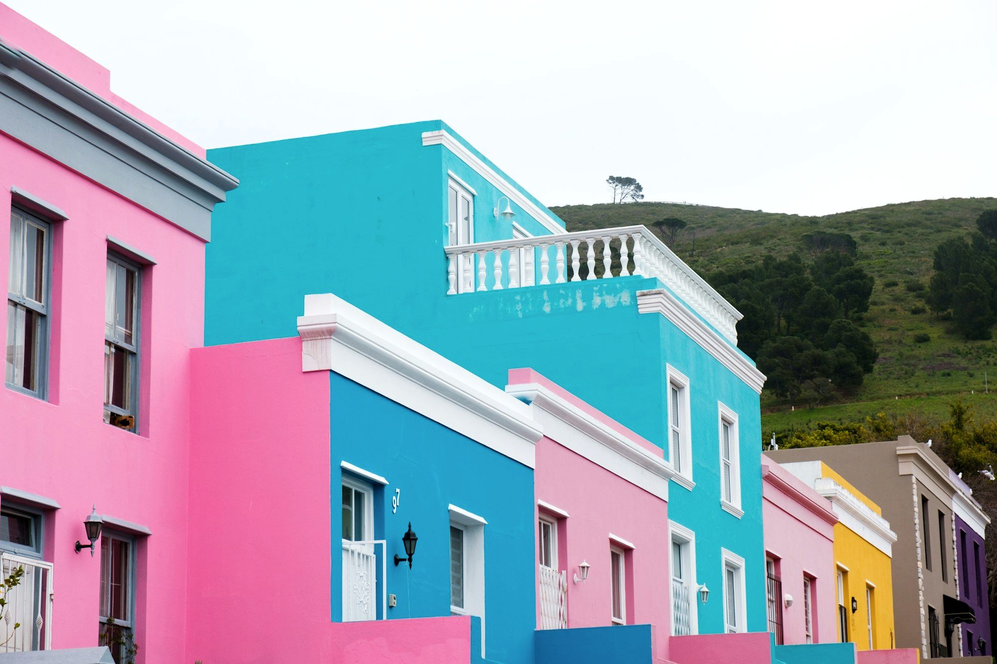 The brightly painted pink, lime, and cobalt houses lining a steep Bo-Kaap street in Cape Town
