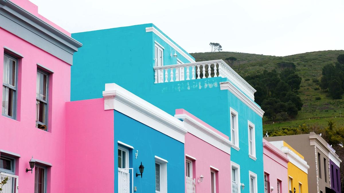 The brightly painted pink, lime, and cobalt houses lining a steep Bo-Kaap street in Cape Town