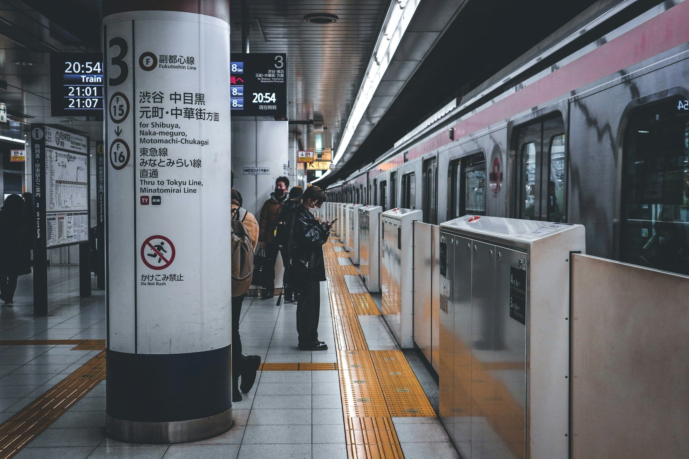 Commuters passing through a busy Tokyo subway station