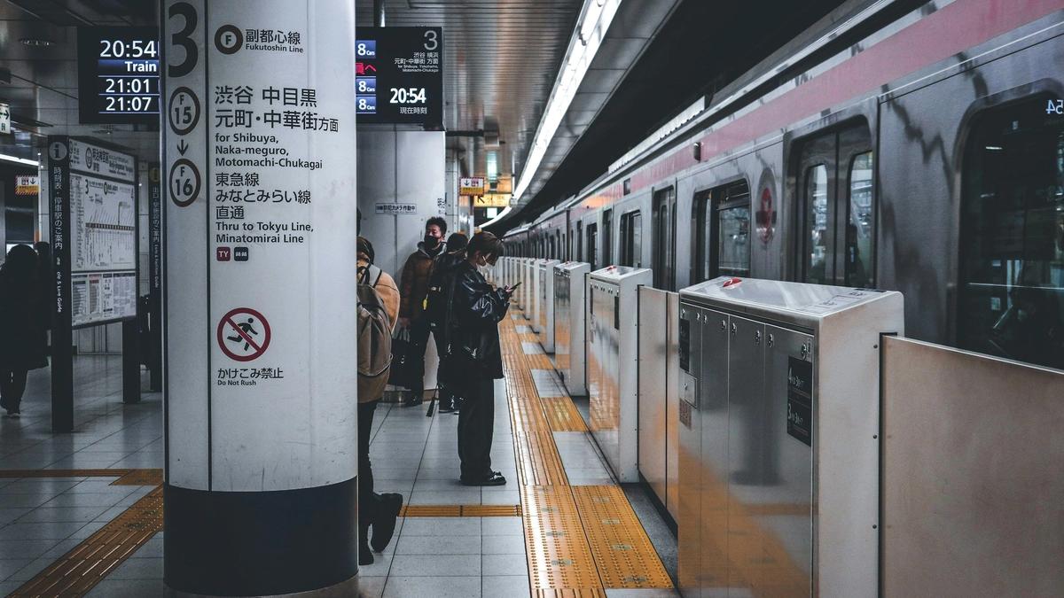 Commuters passing through a busy Tokyo subway station