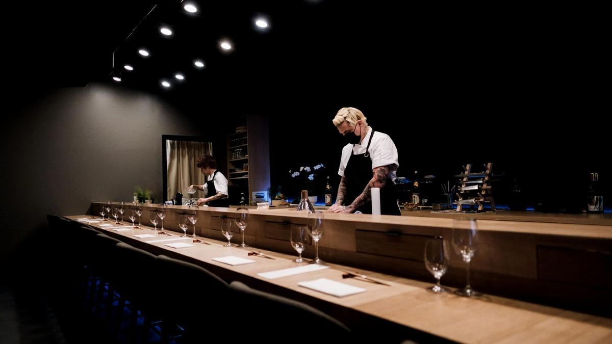 A sushi chef preparing otoro behind an upscale omakase counter in Ginza, Tokyo