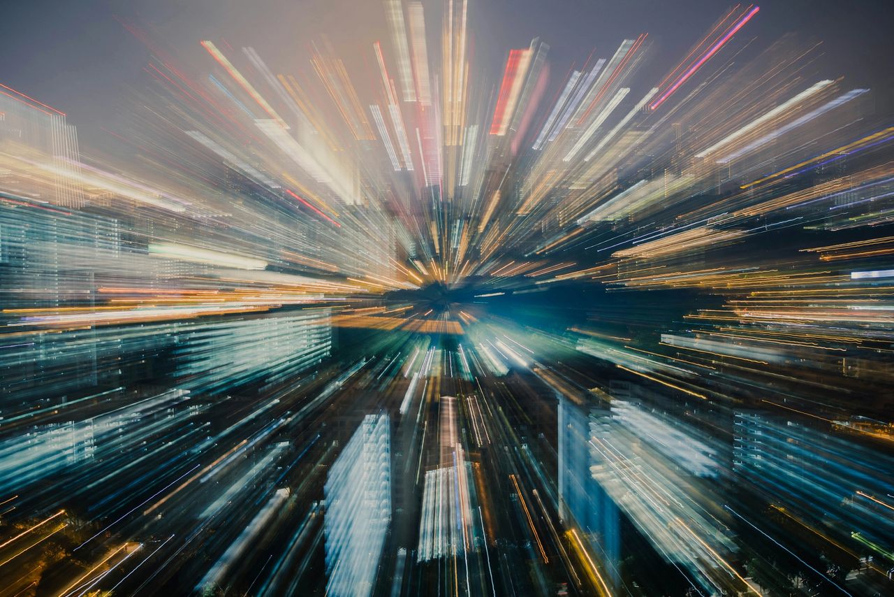 Abstract city skyline with radial motion blur and streaks of light