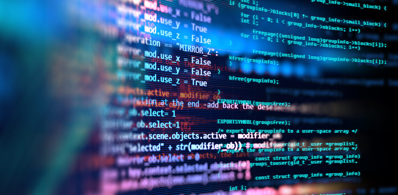 Close-up of colorful programming code displayed on a dark monitor screen