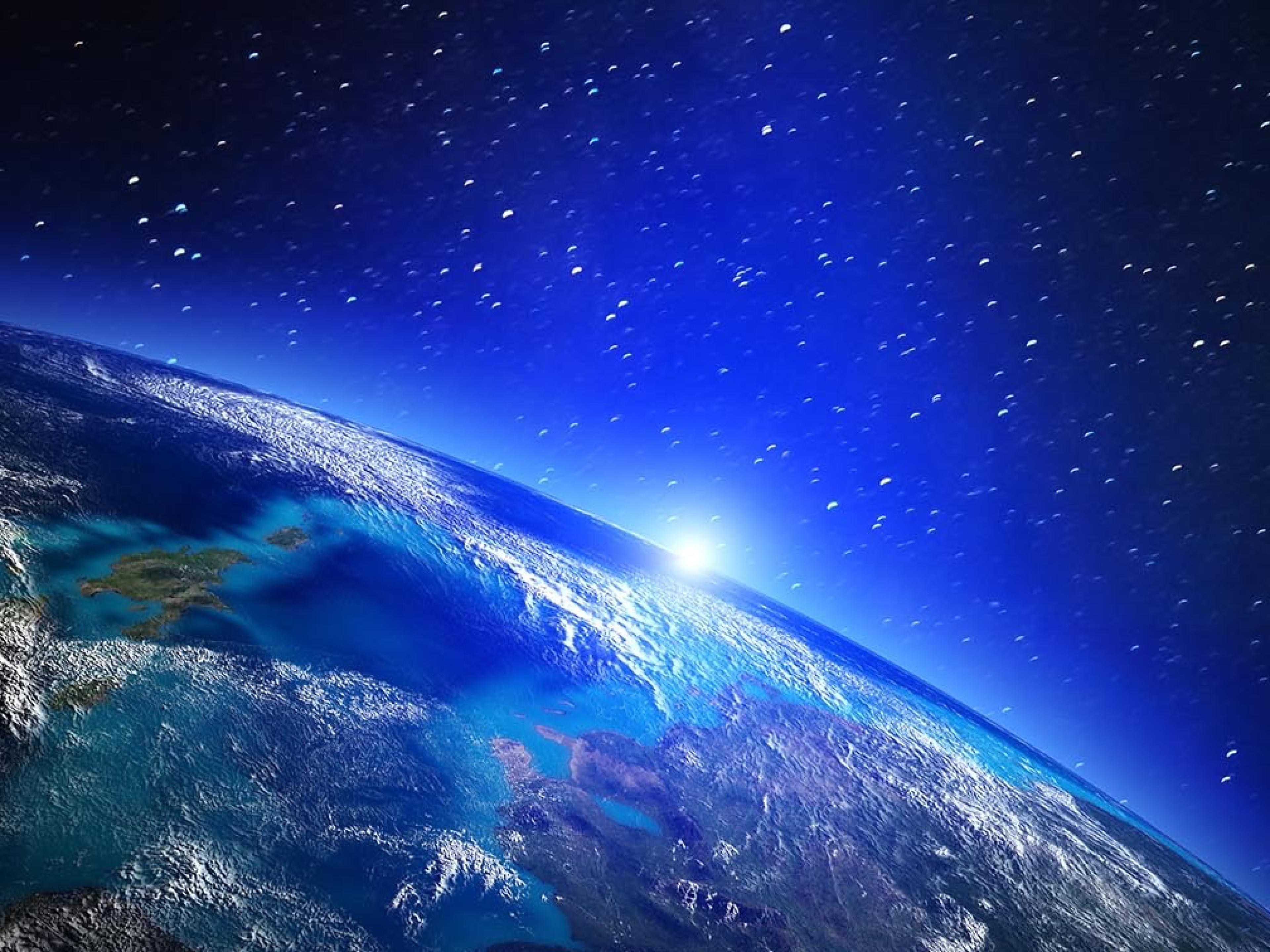 Earth seen from space with a bright blue sunrise on the horizon and stars in the background