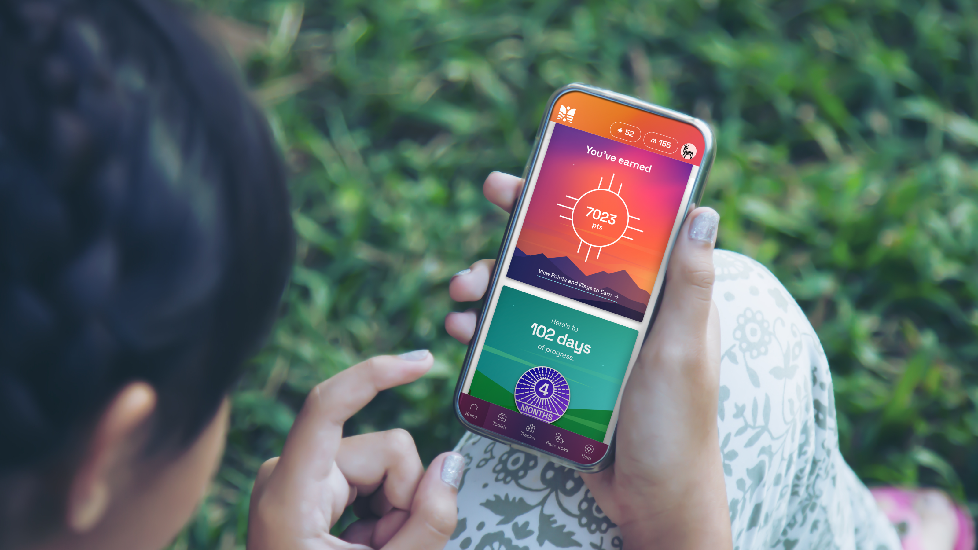 Person using a smartphone wellness app displaying health scores and engagement metrics
