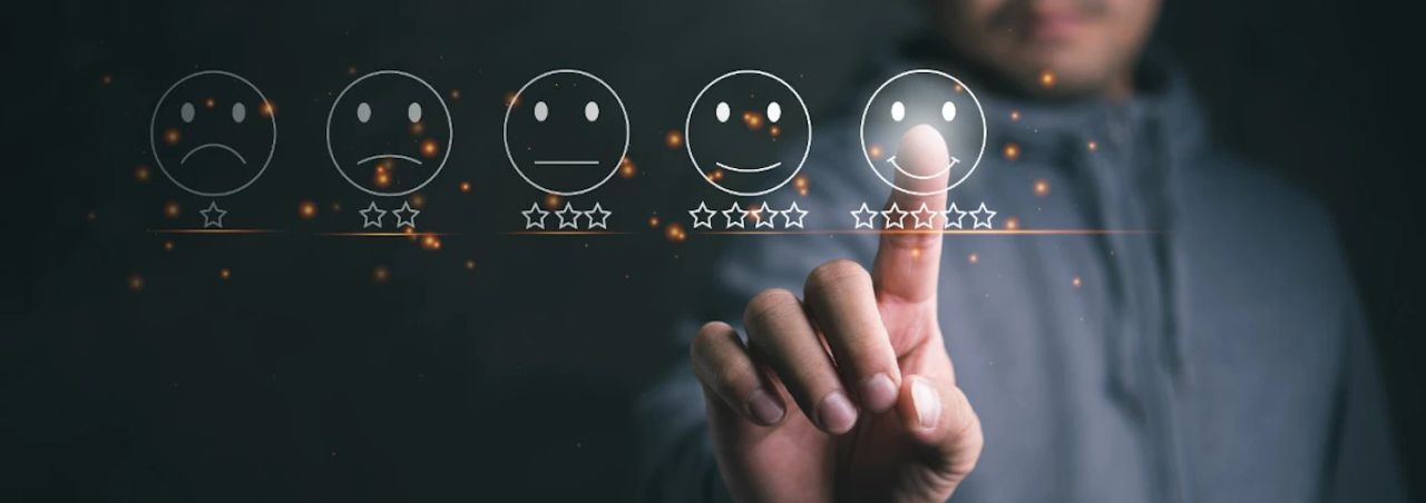 Hand selecting the highest smiley-face rating on a digital satisfaction scale