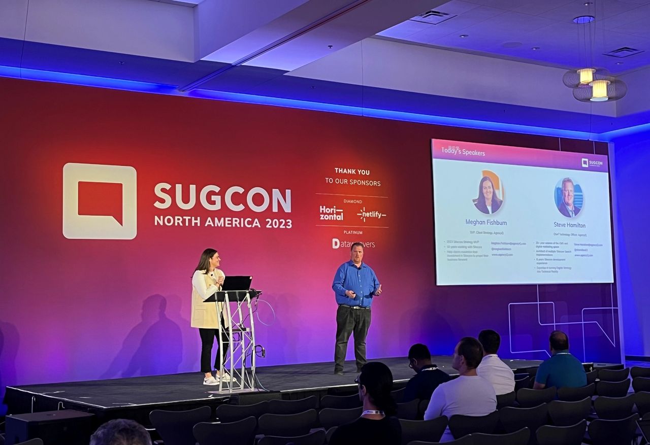 Two presenters on stage at SUGCON North America 2023 conference