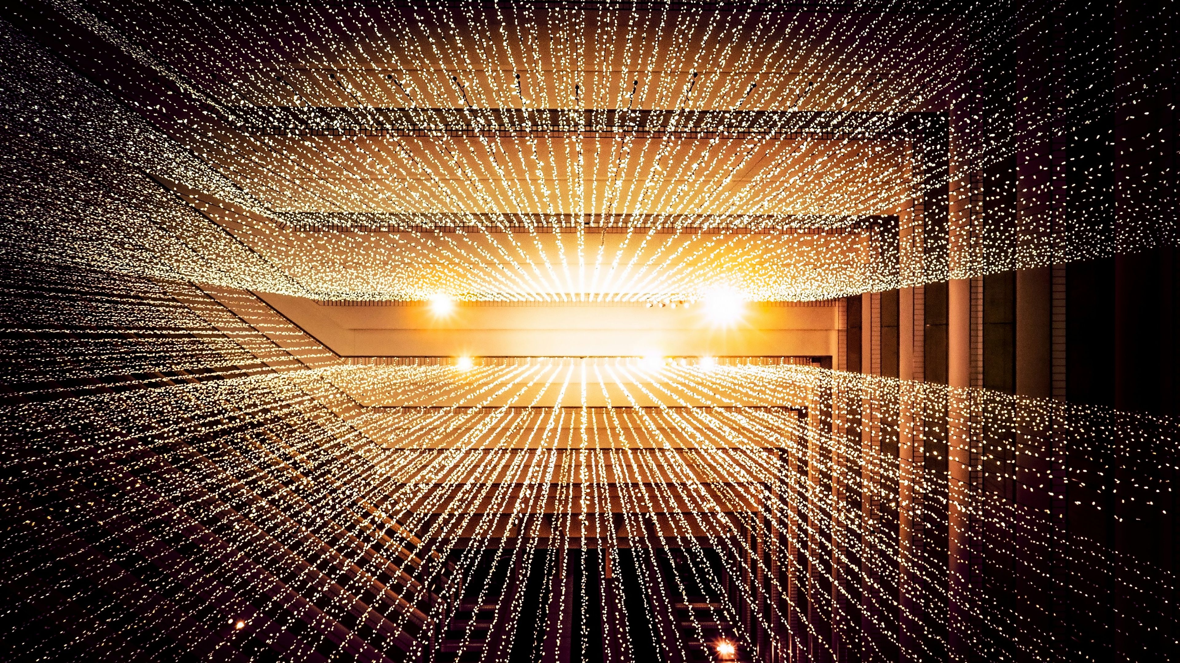 Golden light radiating through a corridor of illuminated data points creating a futuristic tunnel effect
