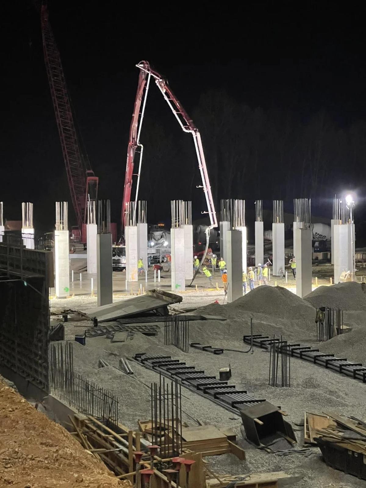 Concrete columns and elevated deck work during a nighttime pour