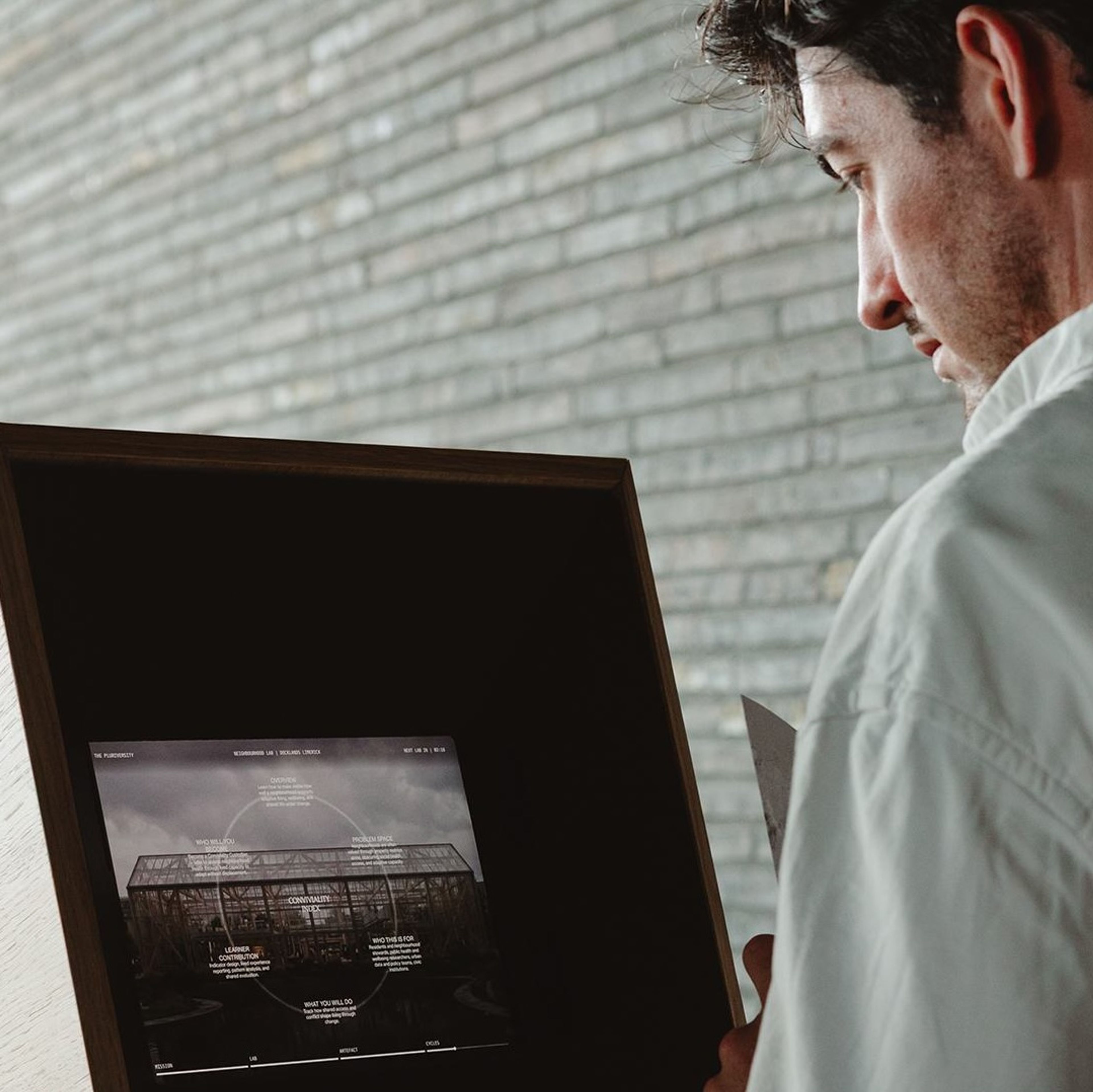 A man interacts with a digital story sequence at an exhibition