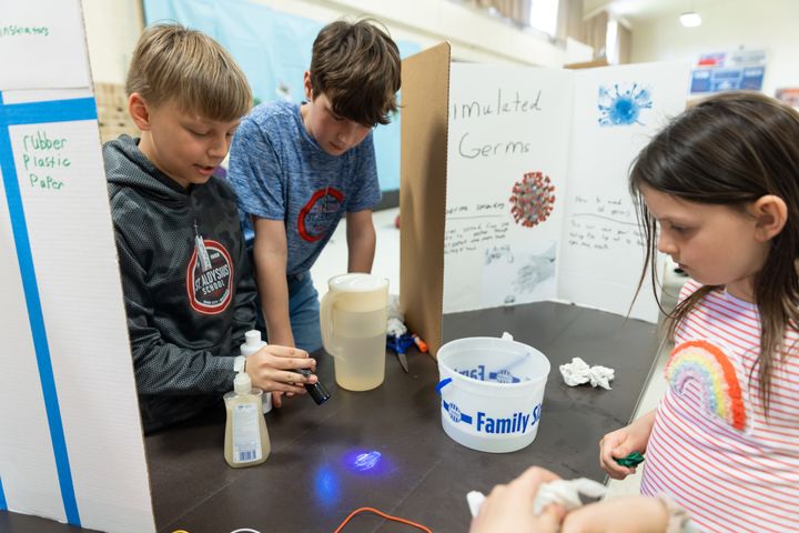 Vos Betley and Connor Kendall (5) educate students about how to stop germs from spreading.