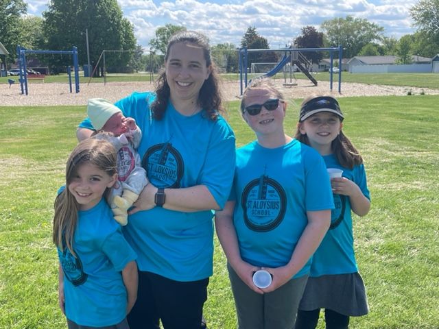 Walkers Cici Krejchik (2), Reagan Hruby (2) and Gena Krejchik (3) pose with teacher Mrs. Amanda Krejchik and her newborn.