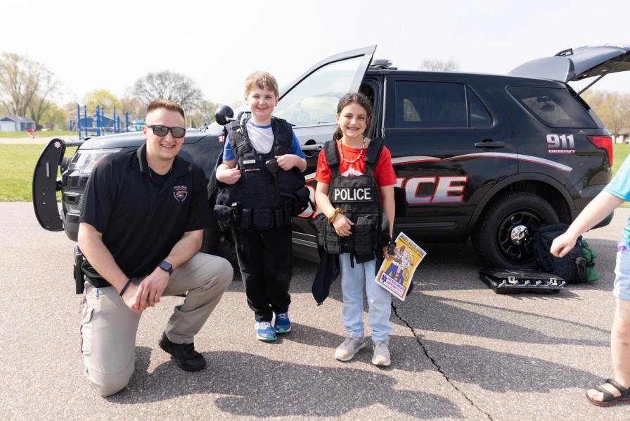 Jericho Kruchten and Valentina Brum (3) try on police vests during the First Responders visit.