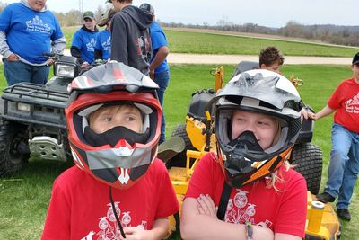 Brynn Dischler and Rhylan Muller test out some ATV helmets.