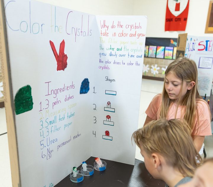 Brynn Dischler (not in photo) and Cloudia Haselwander (4) show how and why crystals can take in color and grow.
