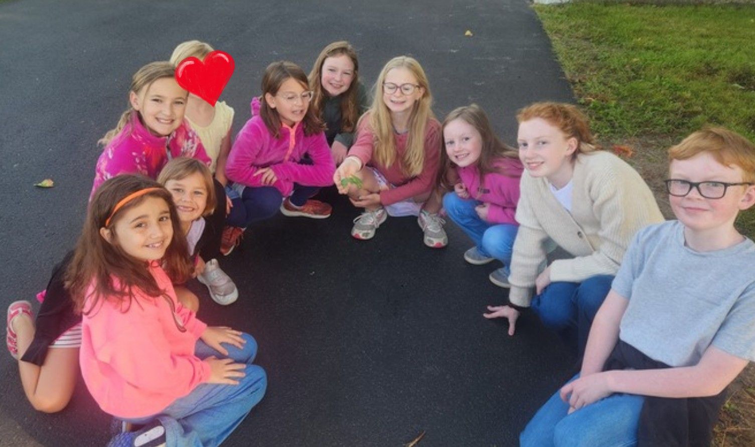 Students gathered in a circle on the blacktop at morning recess.