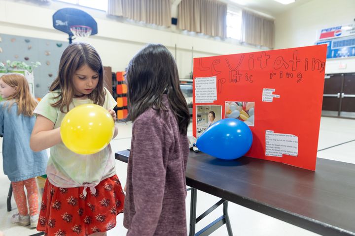 Gena Krejchik (3) shows off her levitating balloon.