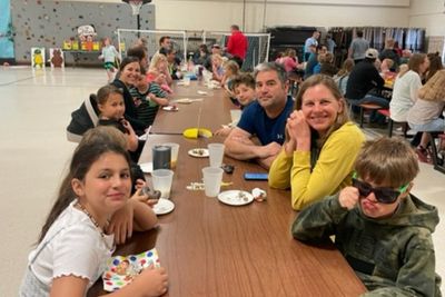 (Right) Parents Mike & Leah Ederer enjoy sweets with their sunglassed son Logan (3). Others joining include (front, going clockwise) Valentina Brum (3), Adalynn Kasper (2), mom Roberta Kasper, James Kasper (K) and Sam Ederer (4 - cousin, behind Mike).