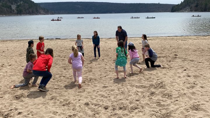The kids play games on the beach.