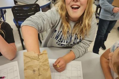 Meg Brickl (5) digs into her "mystery bag" to figure out what's inside.