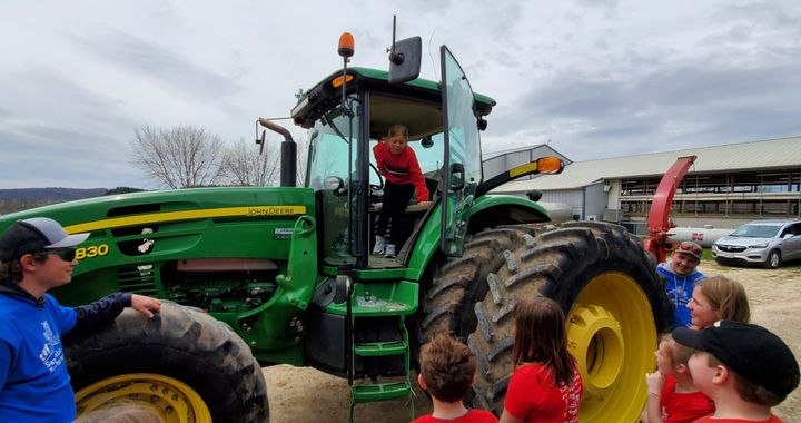 Cloudia Haselwander realizes how high a tractor seat really is!